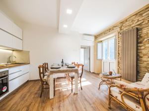 a kitchen and dining room with a table and chairs at Holiday Home Casa Gli Aranci by Interhome in Montignoso