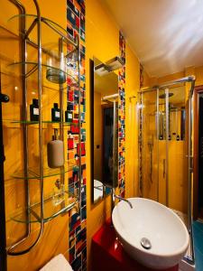 a yellow bathroom with a sink and a shower at La Baita Limone Riserva Bianca Ski-in Ski-out Seggiovia Morel 2 in Limone Piemonte +54 photos