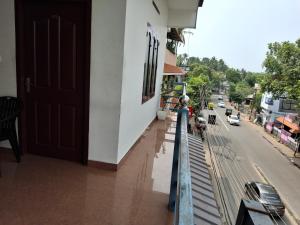 a balcony of a building with a door and a street at Vidara Budget Stay in Trivandrum +6 photos