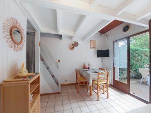 a kitchen and dining room with a table and a window at Holiday Home Les Villas de La Palmyre by Interhome in Les Mathes