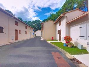 an empty street in a town with buildings at Holiday Home Les Villas de La Palmyre by Interhome in Les Mathes
