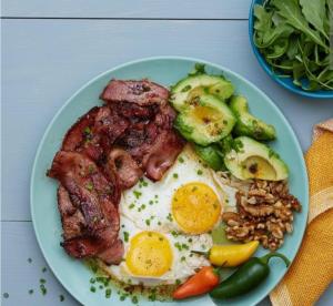 a plate of food with eggs and meat and vegetables at Хостел Sweet Home in Mykolaiv