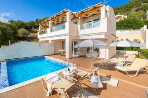 a villa with a swimming pool and a house at Villa Damian in Barbati