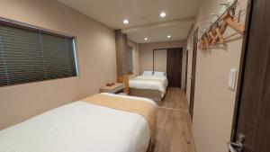 a hotel room with two beds and a window at Dream Stays TSUKI - Vacation STAY 20145 in Osaka