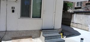 a white door on a house with stairs at Студио за двама в центъра на град Бургас in Burgas City