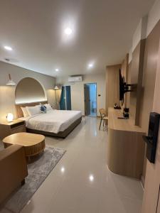 a hotel room with a bed and a living room at Abundant Eco Hostel in Laguna Phuket