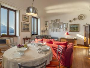 a living room with a table and a couch at Apartment Villa Ceriana-5 by Interhome in Ghiffa