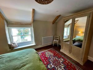 a bedroom with a bed and a window at The Locker, 2 bed apartment in Falmouth in Falmouth