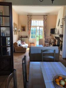 a living room with a bed and a table at Villa Mon But - Maison de maître du 19ème siècle in Hagetmau