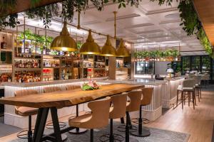 a bar with a wooden table and chairs at Trident Nariman Point in Mumbai