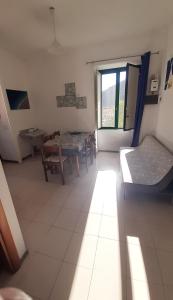 a living room with a table and a couch and a window at Casa Rosa appartamento con giardino in Cetara