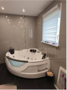 a bathroom with a white tub in a room at L'écrin champêtre, séjour chic et cosy in Waldolwisheim +51 photos