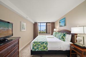 a bedroom with a bed and a flat screen tv at Kaanapali Shores 527 · KS 527 2Bedroom w Ocean Views in BeachFro in Kahana