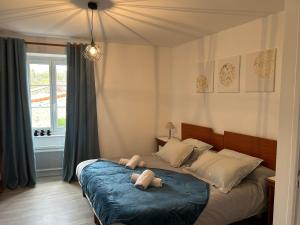 a bedroom with a bed with two teddy bears on it at Chambre Château in Augnat