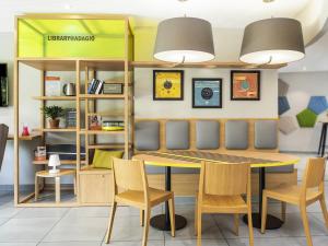 a dining room with a table and chairs at Aparthotel Adagio access Colombes La Défense in Colombes