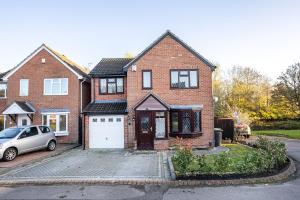 a brick house with a car parked in front of it at Carey House Long Stays Free Parking and WI-FI in Swindon