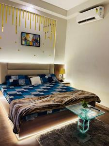 a bedroom with a bed and a glass table at Sixty one stays in Greater Noida