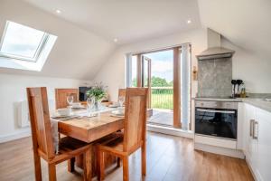 een keuken met een houten tafel en een groot raam bij 1 Bed in Abbeydore oc-l29485 in Abbey Dore