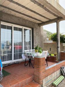 een terras met een tafel op een stenen terras bij Appartement Boulimat Bejaia in Matriouene