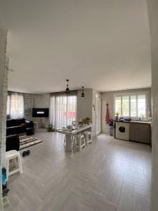 een grote woonkamer met een tafel en een keuken bij Appartement Boulimat Bejaia in Matriouene