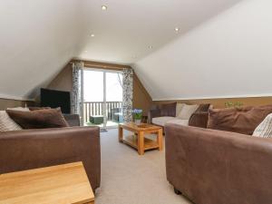a living room with two couches and a window at Valley Lodge 61 in Callington