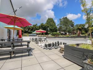a park with benches and a giant chessboard at Valley Lodge 61 in Callington