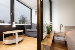 a bedroom with a bed and a table and a chair at Marina Wendtorf Hafenblick in Wendtorf