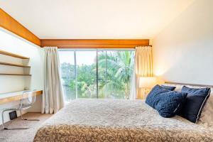 a bedroom with a bed and a large window at Waterfront Home by Ralph Twitchell in Sarasota