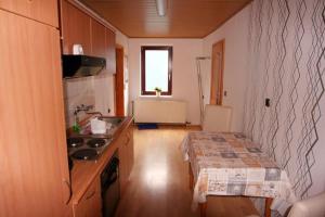 a small kitchen with a sink and a counter top at Mönch in Harztor