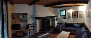 a living room with a couch and a fireplace at Casa Anna in Avegno +8 photos