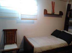 a small bedroom with a bed and a window at Villa La Perla De Sonabia in Oriñón