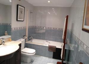 a bathroom with a tub and a toilet and a sink at Villa La Perla De Sonabia in Oriñón +35 photos