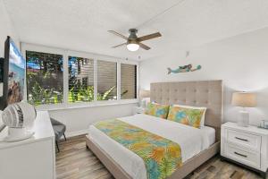 a bedroom with a bed and a ceiling fan at Kamaole Sands 1101 · KAS 1101 Updated Beachy Chic 2BD Across Bea in Wailea +44 photos