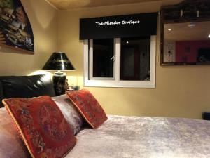 a bedroom with a bed with two pillows and a window at Have tonights dreams wrapped in Chinese silk in Swansea