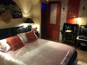 a bedroom with a bed with two pillows on it at Have tonights dreams wrapped in Chinese silk in Swansea