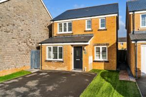 an empty driveway in front of a brick house at Finest Retreats - Ffordd Y Meillion in Llanelli