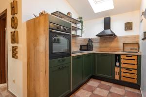 a kitchen with green cabinets and an oven at Haus Vita in Pula