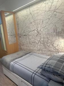 a bedroom with a bed and a wall mural at Unique space in Edgware in Stone Grove +11 photos