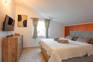 a bedroom with a large bed and a television at Haus Vita in Pula +33 photos