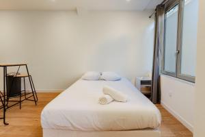 Giường trong phòng chung tại Le Chapelier