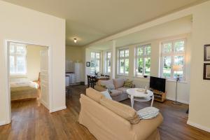 a living room with a couch and a table at Wohnung Im Ersten Obergeschoss Des Gutshauses in Neuenkirchen