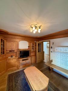 a living room with wooden cabinets and a table at Pragma Apartments - Casa Defrancesco in Cavalese