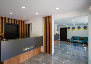 an office lobby with a reception desk and a couch at Suya Studios by HolidayKeys in Karavas