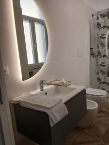 a bathroom with a sink and a mirror and a toilet at boutique teatro b&b in Foggia +41 photos