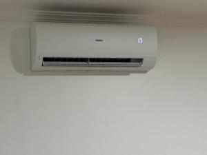 a air conditioner is hanging from a ceiling at Alforra Residence 1-T2-centro-praias-Levadas in Câmara de Lobos