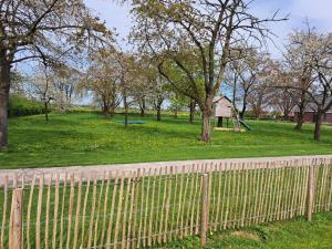 a fence in front of a park with a playground at B&B Landlust in Ons Belang