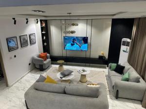 a living room with two couches and a flat screen tv at Primefix in Lekki