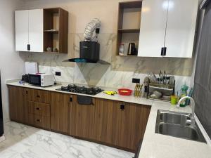 a kitchen with a sink and a stove top oven at Primefix in Lekki