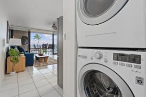 a white washer and dryer in a living room at Milowai 302 · MIL 302 Oceanfront 2BD w Ocean Views Whale Watch in Wailuku