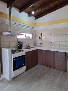 a kitchen with a stove and a sink at Cabañas, La Punta Vista Serena in La Punta